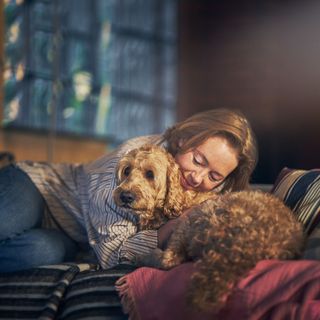 Frau kuschelt mit Doodle